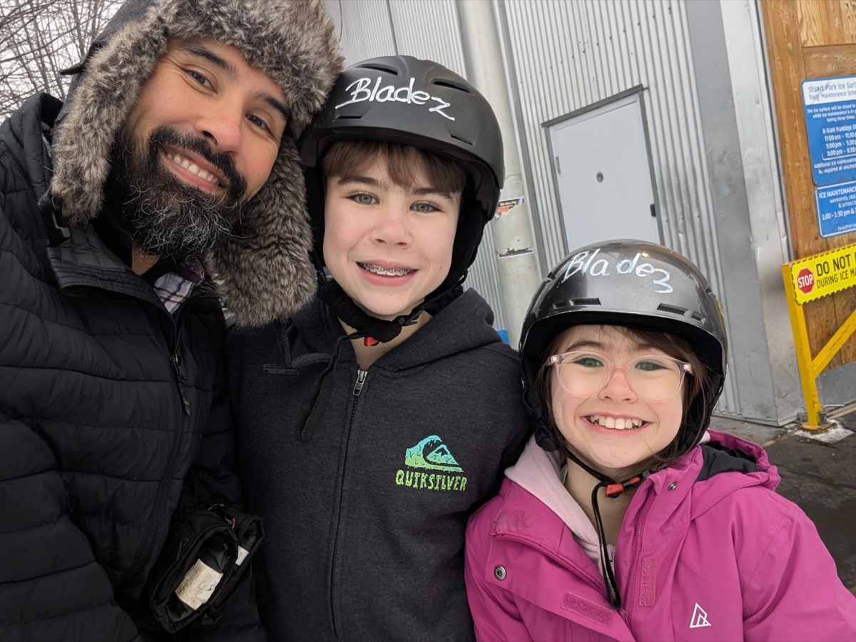 Chris with his two kids at the skating rink